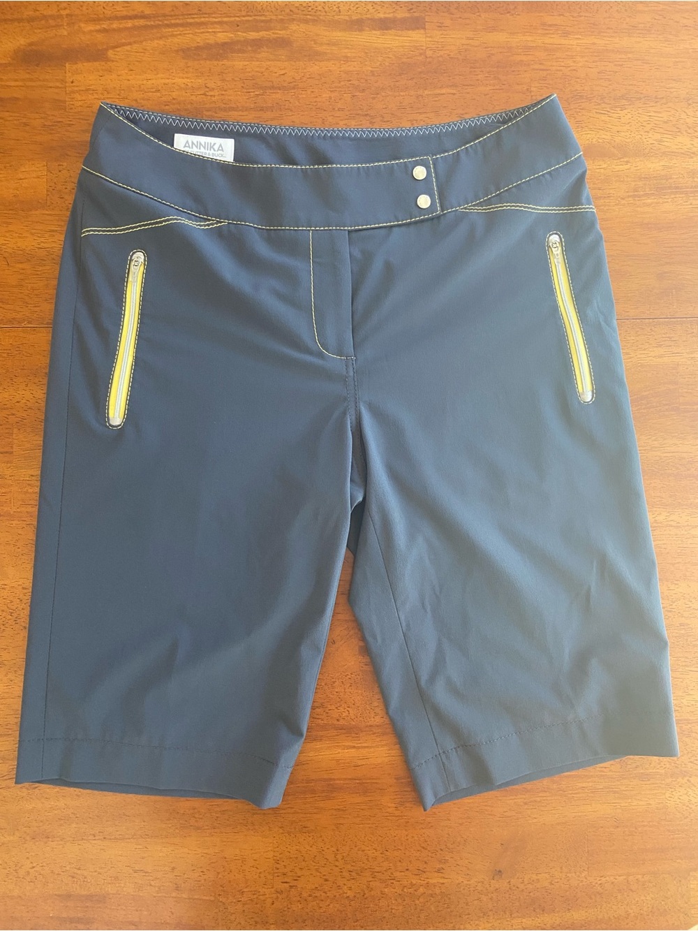 ANNIKA Women's Navy Golf Shorts with Yellow Zip Accents
